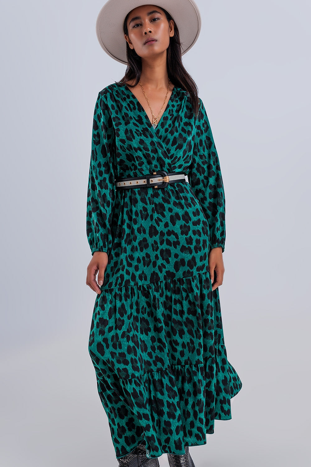 Modern dress with V-neckline, black and green animal print. Boho style
